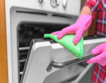 How do I clean a glass oven door